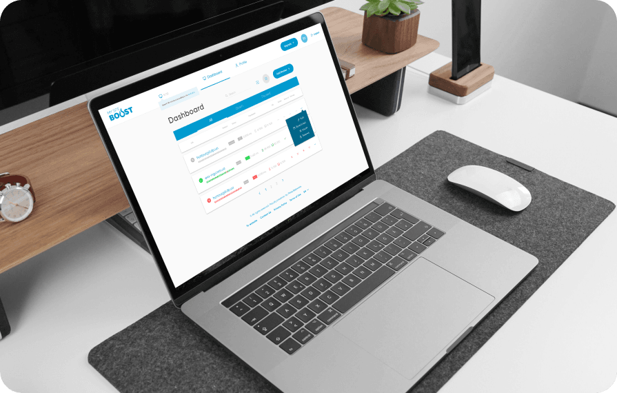 A laptop displaying the MySiteBoost website dashboard, featuring site monitoring data for different web services