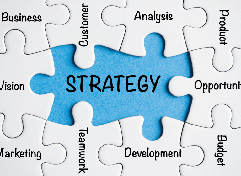 Strategic planning as the central piece in business success Strategy concept illustrated as a blue puzzle piece surrounded by words like marketing, analysis, development, and teamwork.
